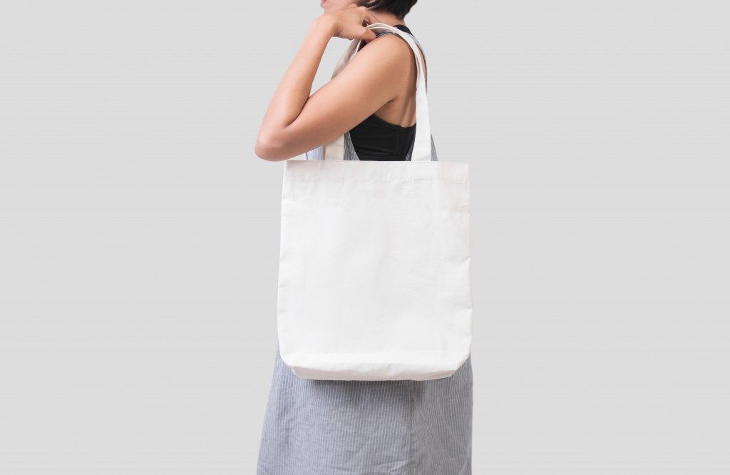 woman carrying a canvas bag