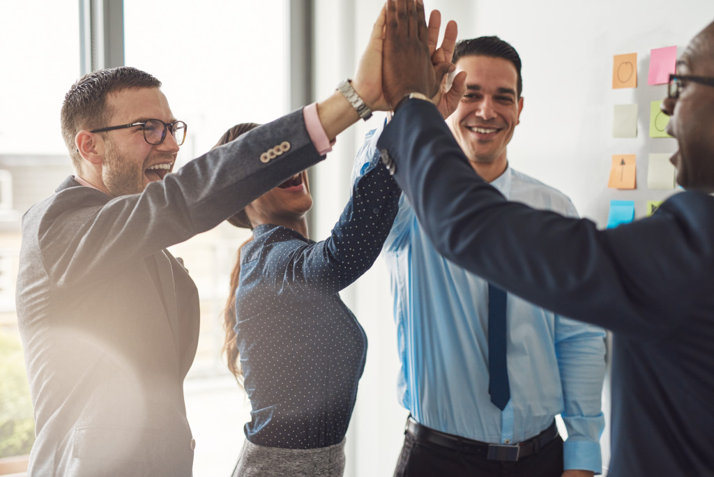 employees doing high-five agreeing with each other