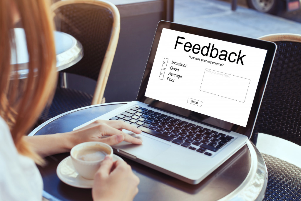 a woman answering a feedback form using a laptop