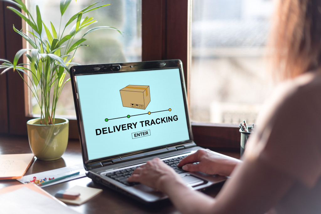 woman tracking delivery using her laptop